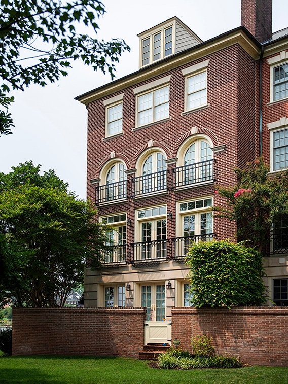 Double-hung wood windows on red brick exterior on traditional home in Alexandria. 