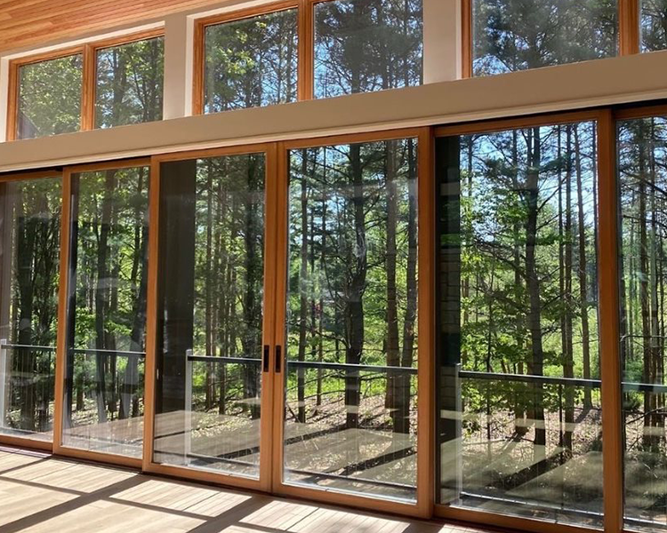 natural wood hinged doors with windows as transoms