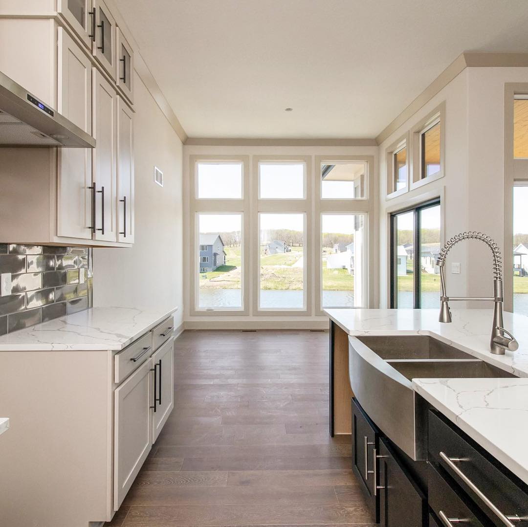 Narrow kitchen looks bigger with floor-to-ceiling casement windows