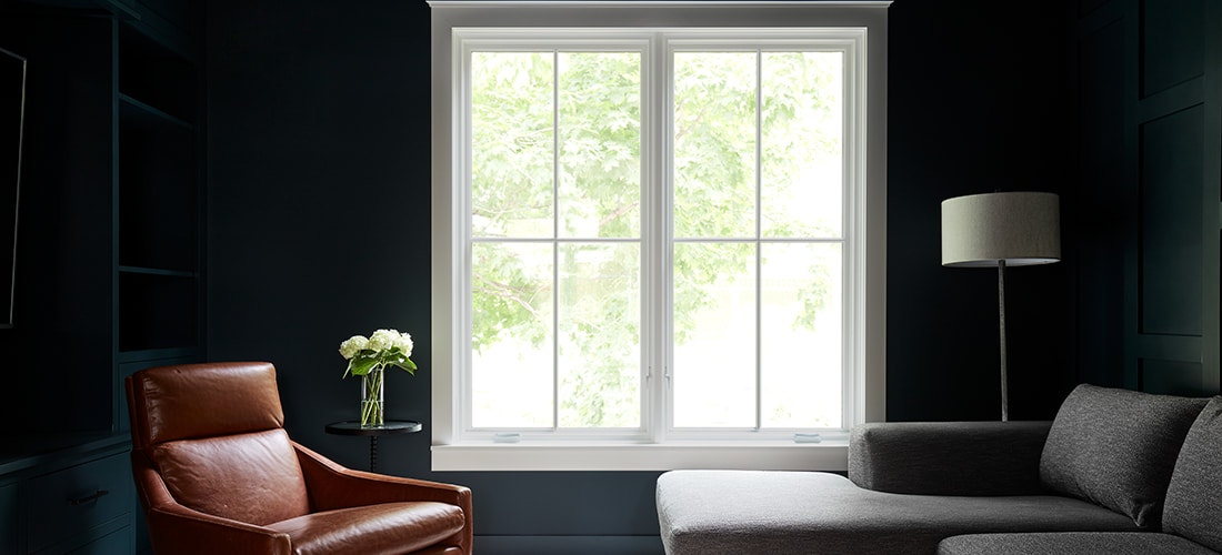 two white wood reserve traditional casement windows on a black wall