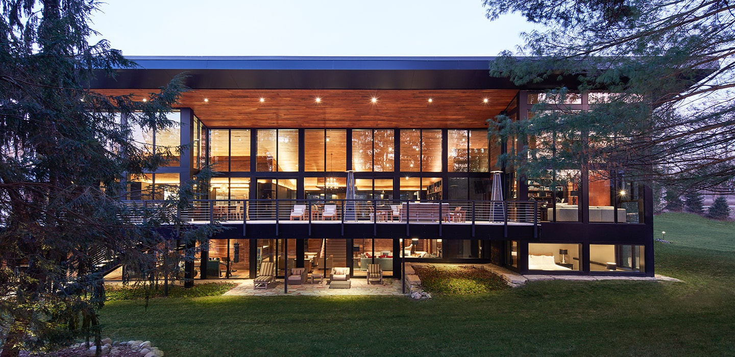 exterior of a two-story contemporary home with glass walls