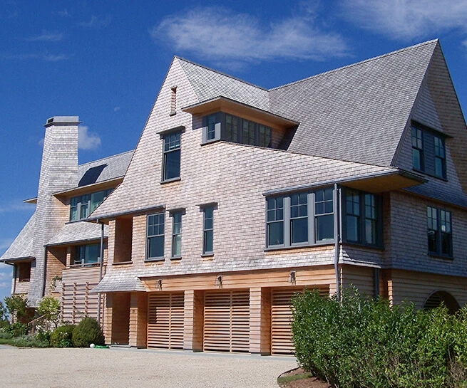 Outside view of a Westerly coastal retreat with newly installed custom wood windows.