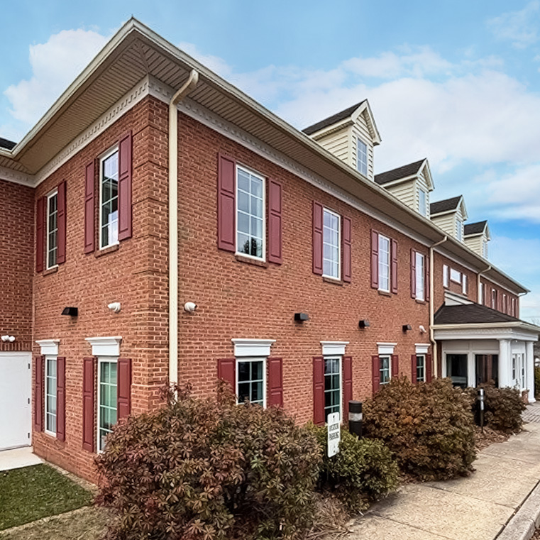 Corner view of a brick commercial property in Pottstown, PA featuring new energy‑efficient Pella windows.