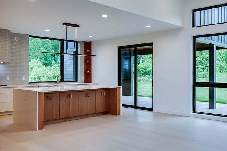 Interior view of black kitchen windows and patio doors.