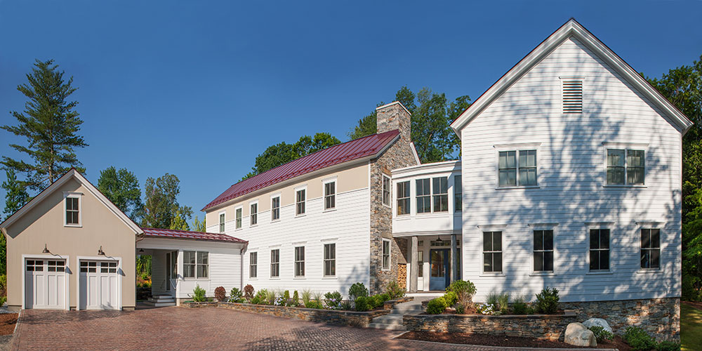 Curbside view of a Berkshire home with newly installed Pella white windows.
