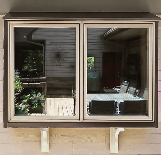 After image of an exterior almond colored casement window above a kitchen sink. 