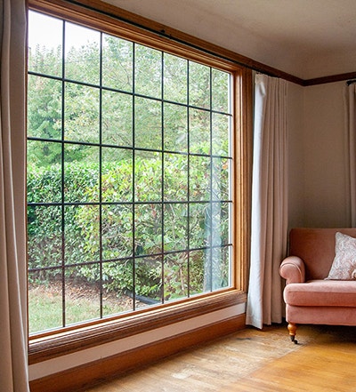 a new Pella wood picture window with drapes 