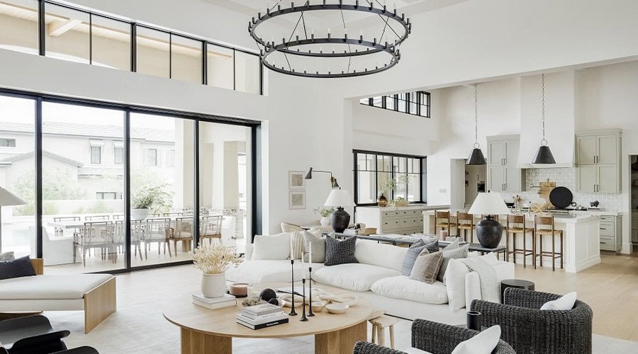 a contemporary living room in white with black multi-slide doors and pass-through windows.