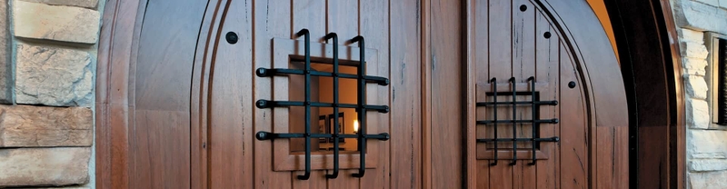 solid wood entry door with decorative elements clavos and speakeasy