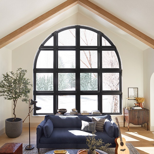 Black arched window with couple sitting on blue couch