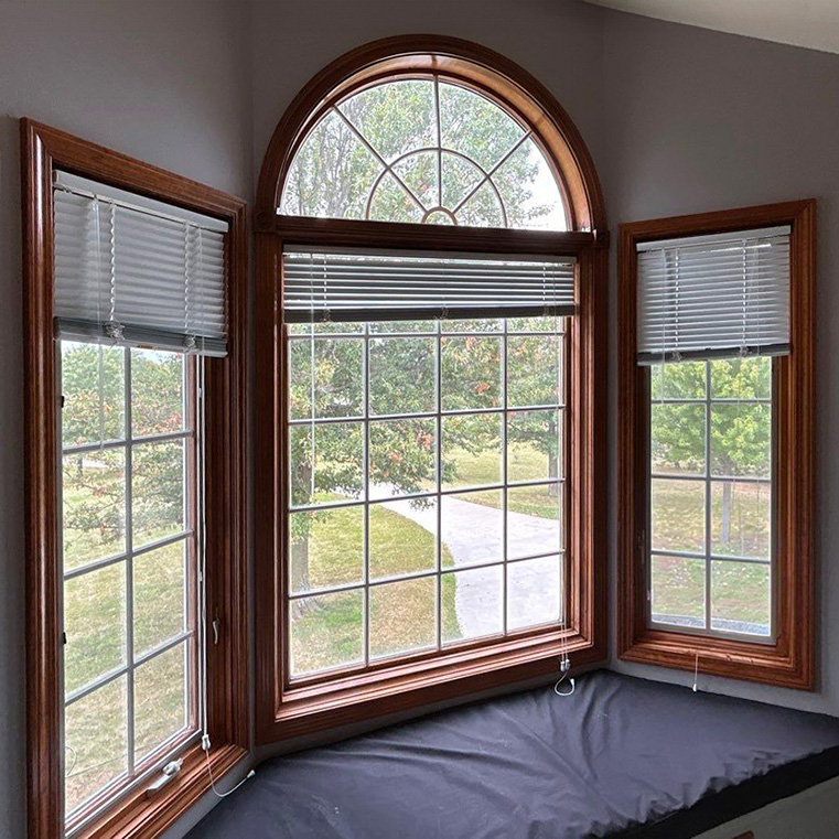 A before image of a room with wooden frame windows, showcasing the need for energy efficient windows.