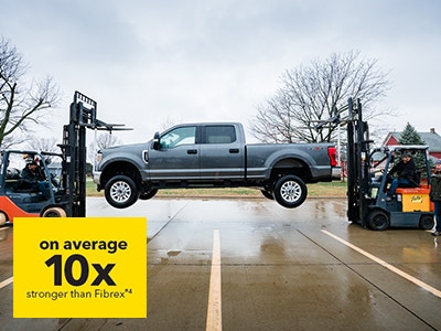 gray pickup suspended from window sill with statistic over the corner