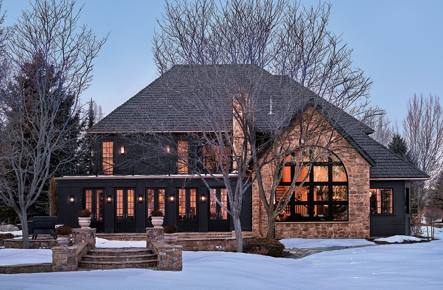 Back exterior of Chris and Julia home with brick and black siding and black roof