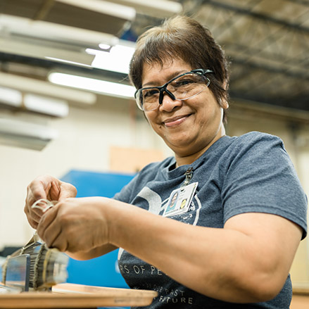 woman working on blinds in pella's factory