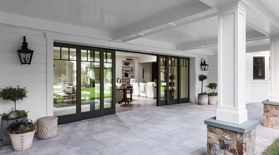 A covered patio with an expansive pocket door configuration leading to the interior.