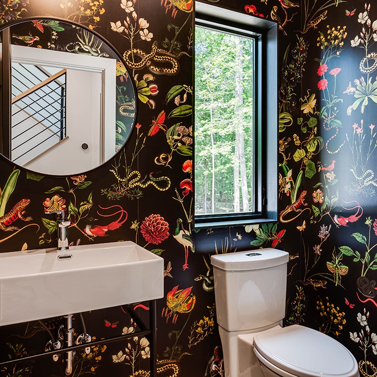 Powder bathroom featuring black window and bold black wallpaper.