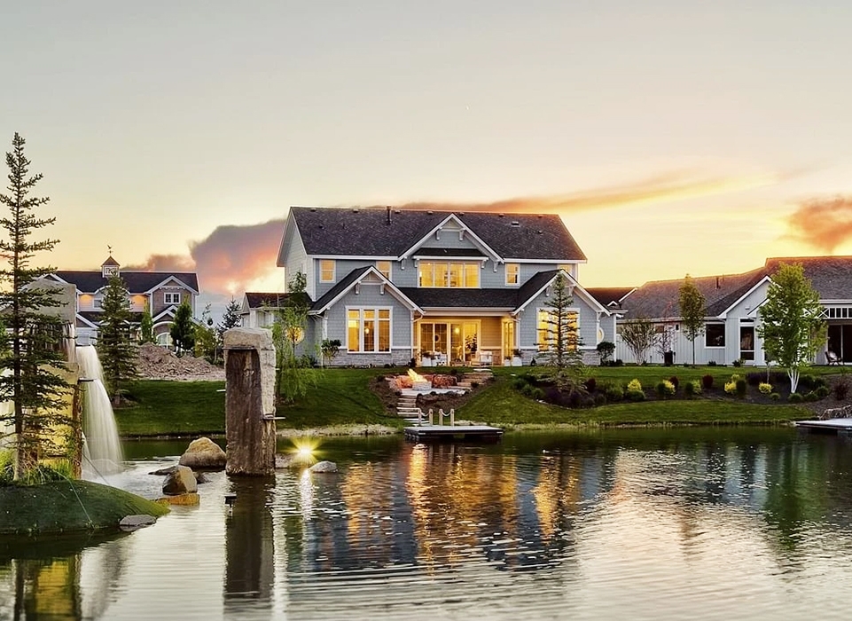 Outside view of a newly constructed Boise home near a lake with newly installed Pella Impervia fiberglass windows.