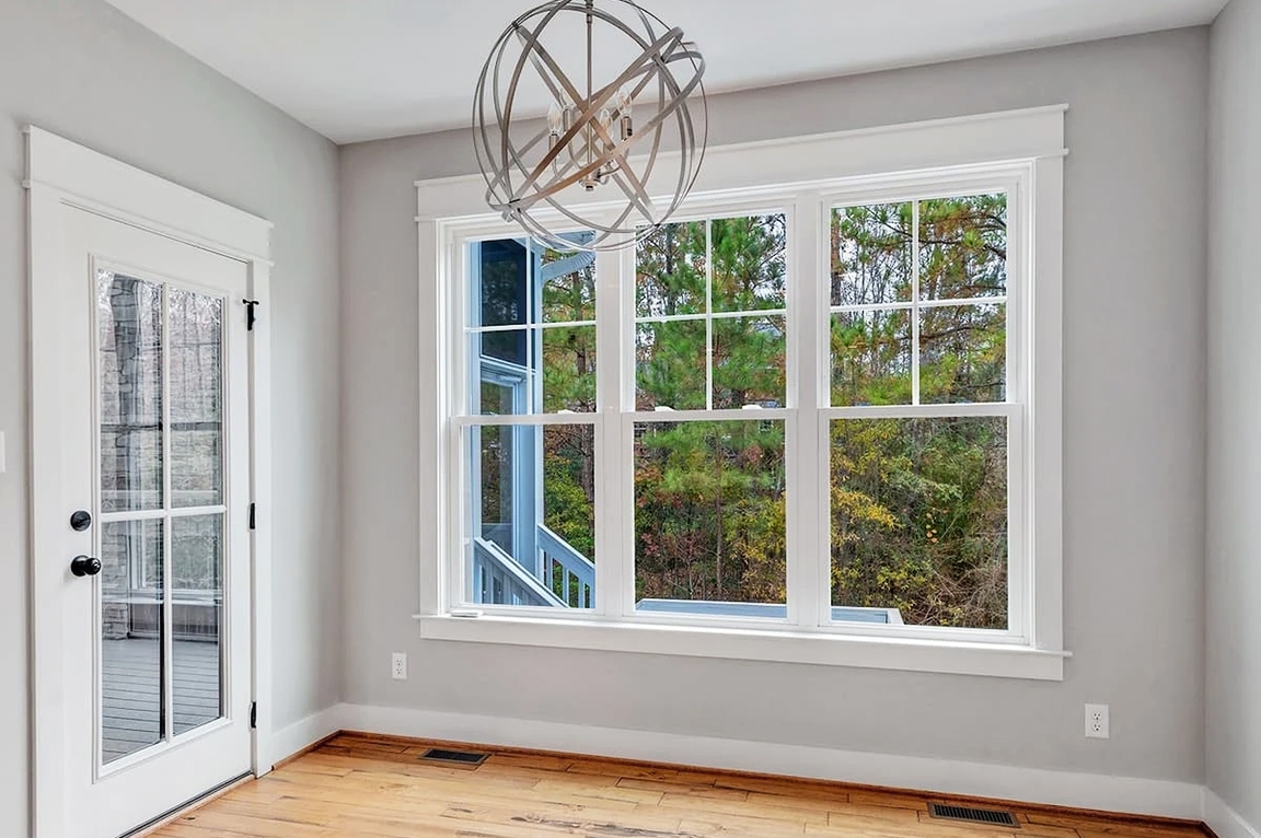 Richmond home living room with white-double hung windows. 