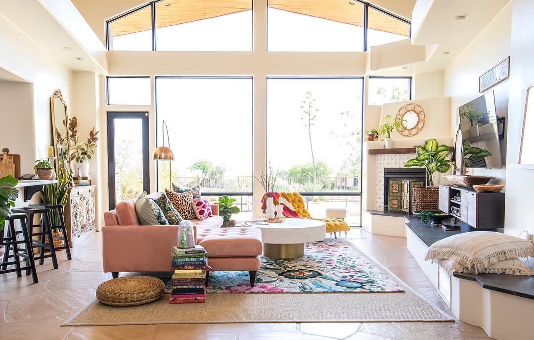 Large, special shape windows and a hinged patio door come together for a wall of glass in eclectic living room