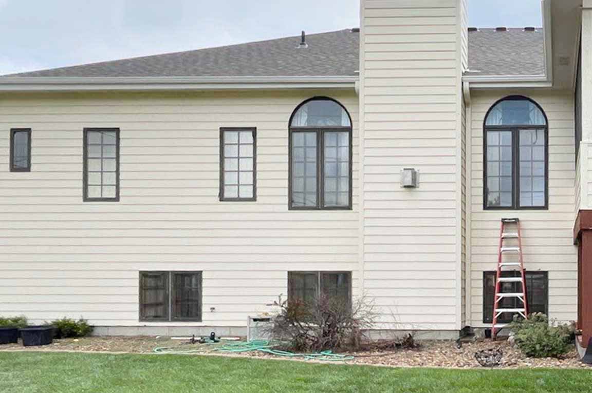 Exterior view of home before window replacement.