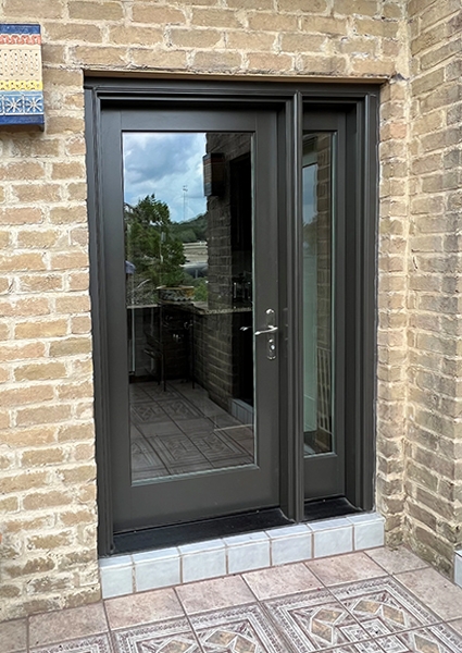 Closeup of newly installed hinged patio door on San Antonio home.