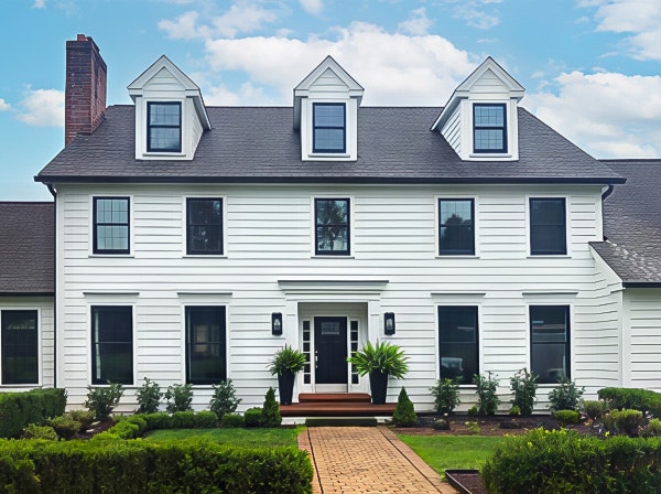 Curbside view of a New Hope colonial style home with modernized updates including newly installed Pella black windows.