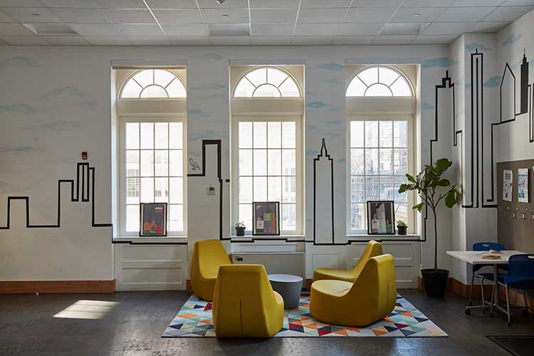 interior of the harlem living room with yellow accent chairs