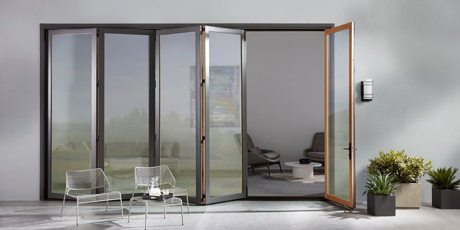 Bi-fold sliding patio doors opened up to sleek, modern living space