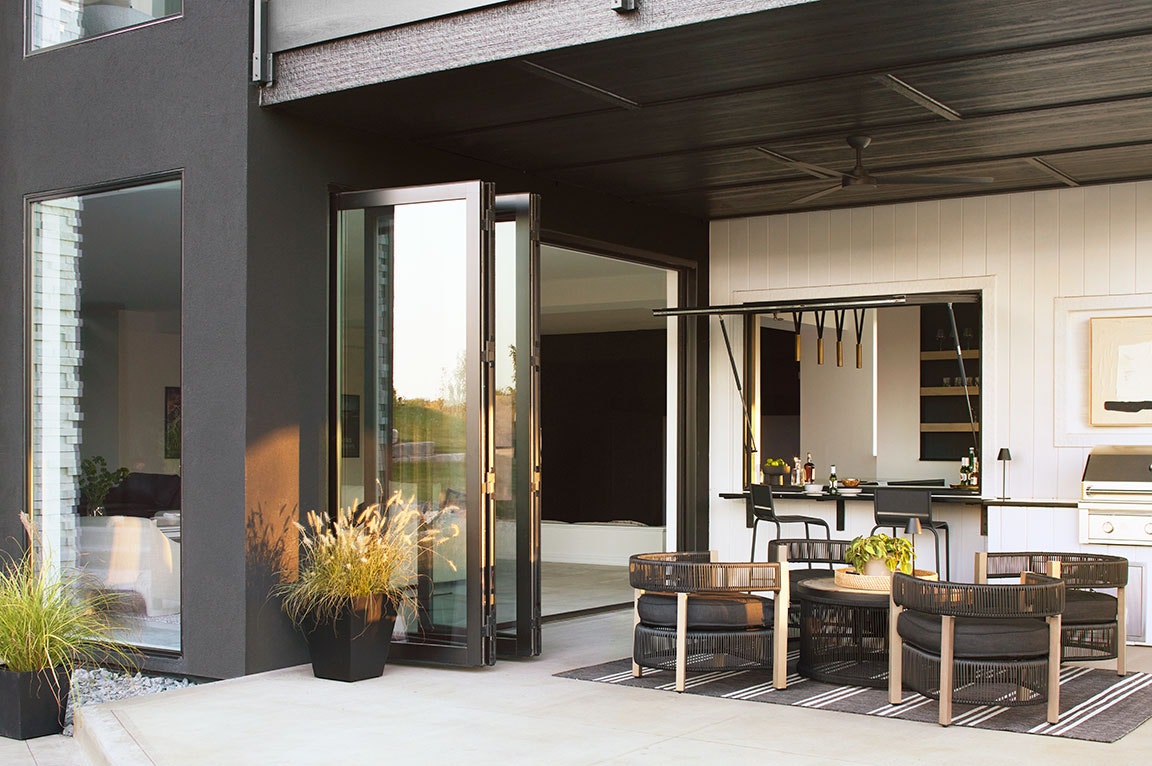 Bi-fold sliding patio doors opened up to sleek, modern living space