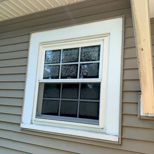 Outdated vinyl window on Vermont home.