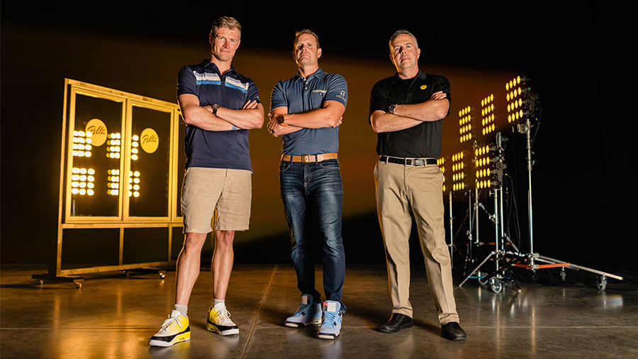 Three men standing in front of a testing chamber for Pella windows