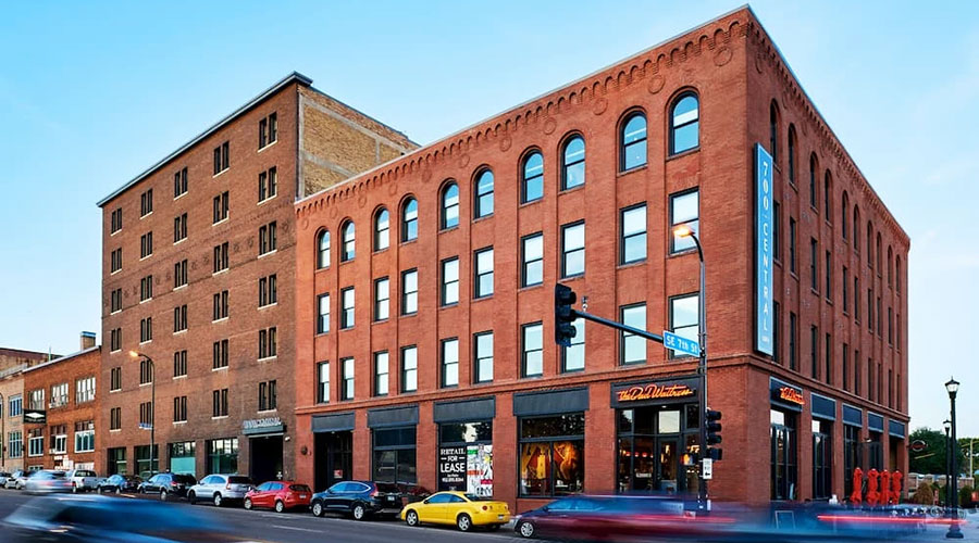Street view of an apartment building in Minneapolis with newly installed custom windows and bifold patio doors.