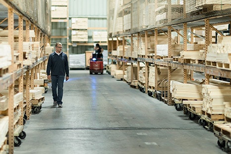 pella factory worker working with raw wood