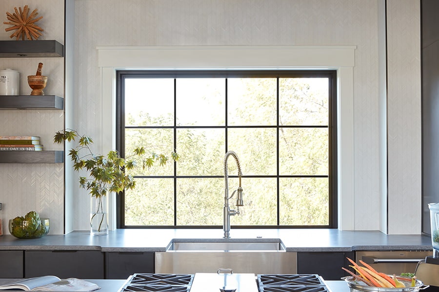 Large black awning window with grilles-between-the-glass over a modern farmhouse sink.