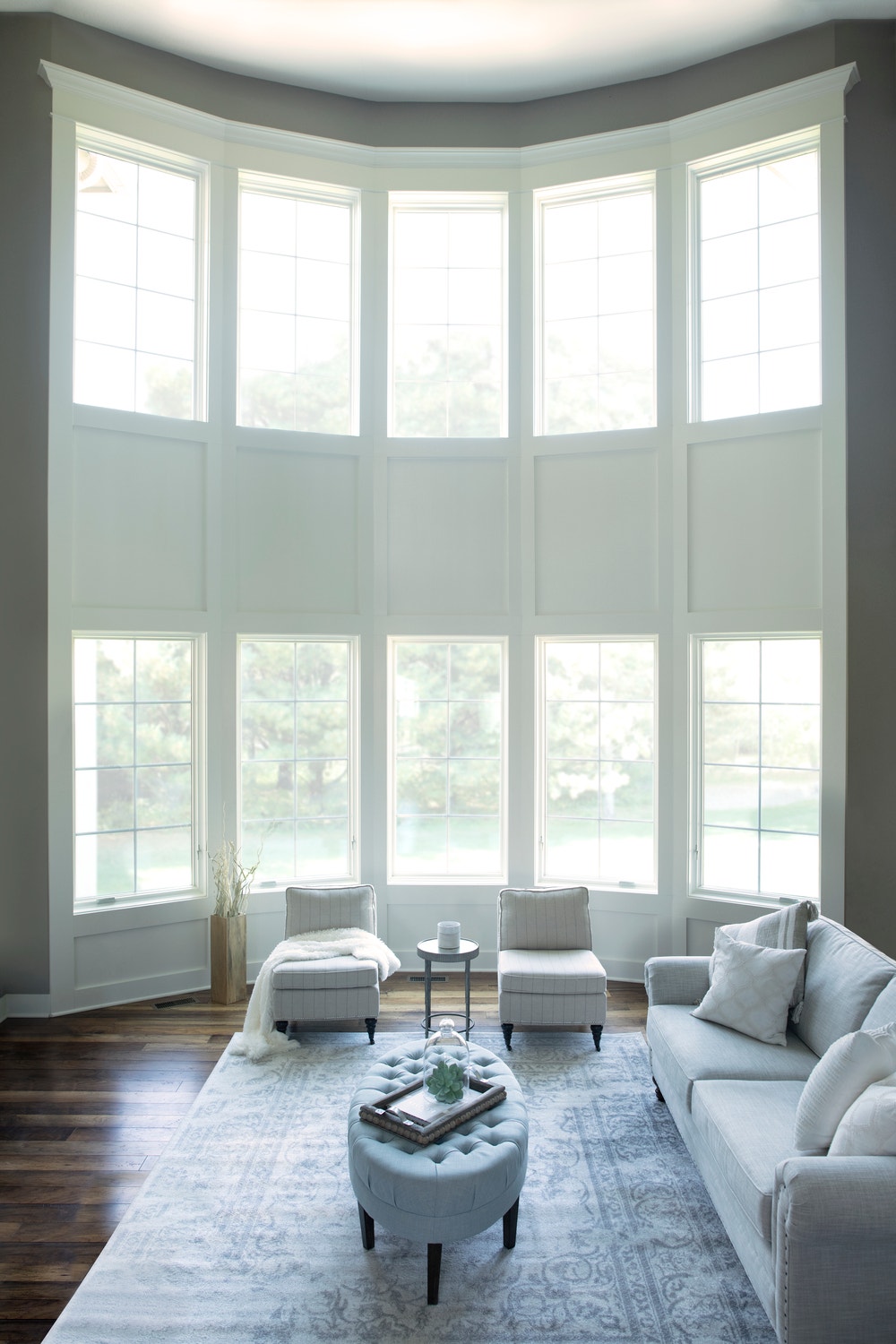 Stacked casement windows create floor-to-ceiling window wall in a living room
