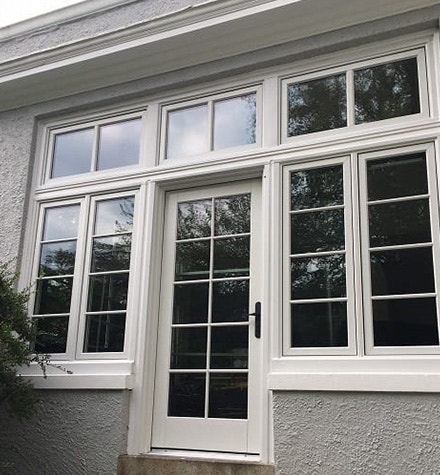 a brand new white hinged patio door and windows on an old Colonial Delaware home