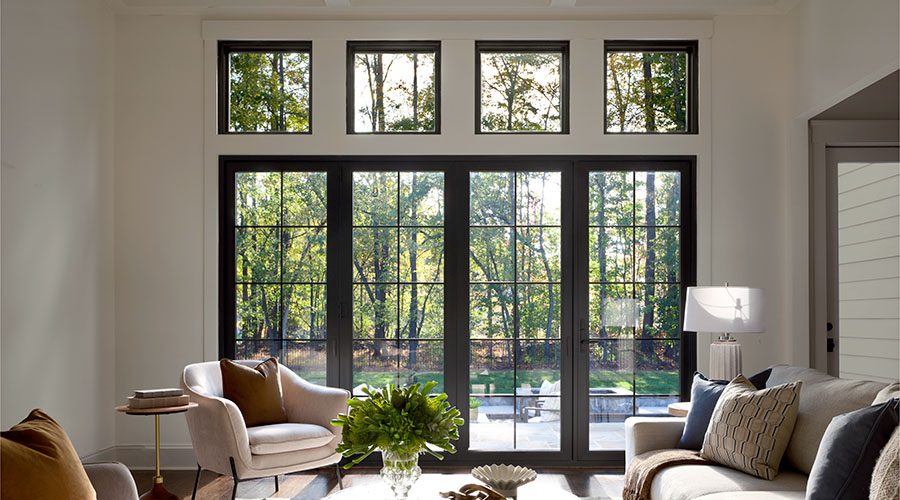 Modern living room with black bifold glass doors and natural light.