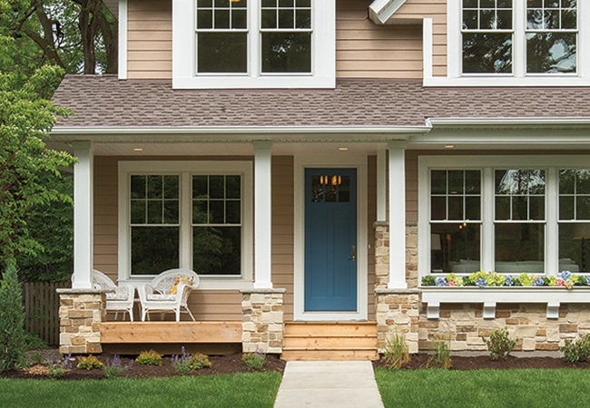 Tan house with blue door.
