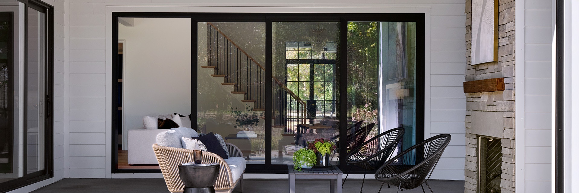 Modern patio with Pella Windows and doors featuring large sliding glass doors and stylish seating.