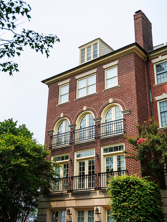 Wood windows on traditional home with a red brick exterior in Alexandria. 
