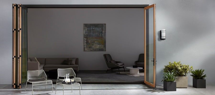 Open bifold doors from patio into a contemporary living room