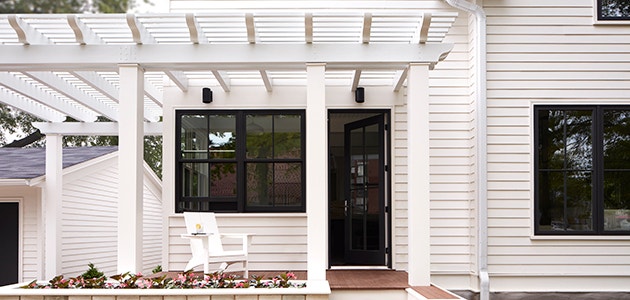 white home exterior with black-trimmed windows and grilles
