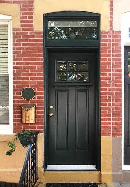 a brand new black fiberglass entry door with dentil shelf
