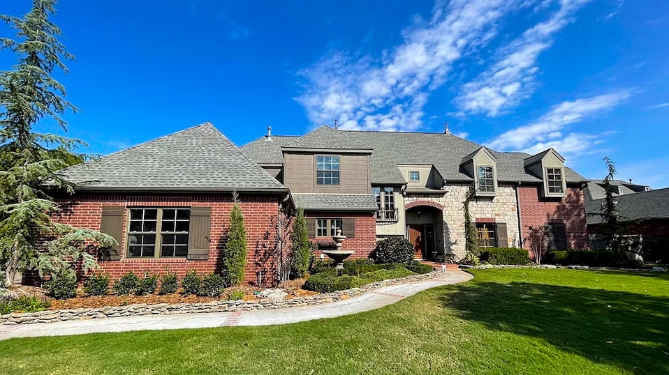 A home in Broken Arrow with newly replaced brown vinyl windows.