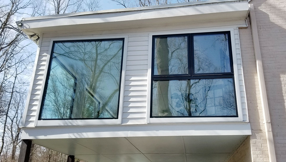 Exterior view of newly installed black windows in Richmond sunroom.