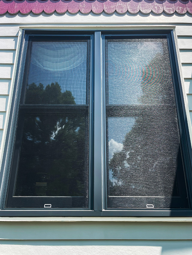 Close-up of newly installed energy-efficient windows and siding after full home replacement project.
