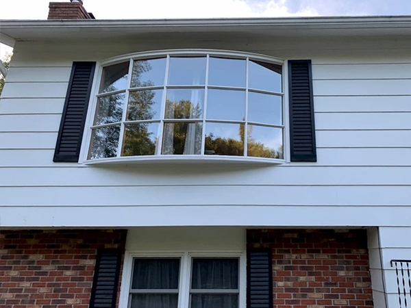 Before image of an outdated bow window on a South Burlington home in need of replacement. 