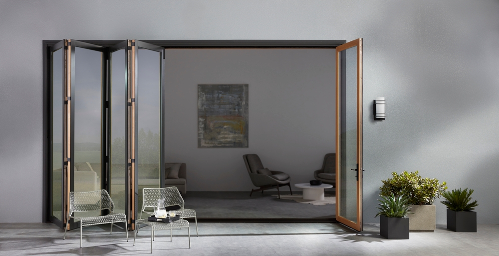 Contemporary Bifold Patio Door Folds Neatly To The Side Black bifold patio door open and folded like an accordian on gray stucco home