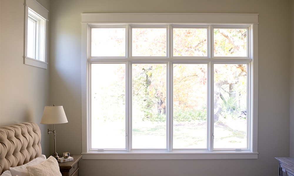 Calming taupe for a bedroom color scheme with 8 tan windows to bring light into the room.