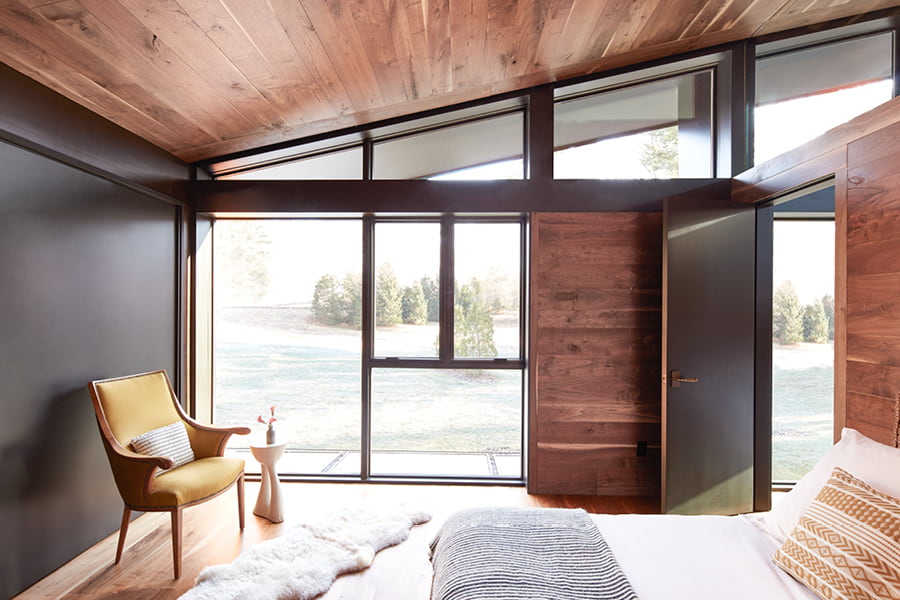 Bedroom with floor to ceiling windows that extends into entryway